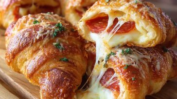 Golden croissant rolls stuffed with mozzarella and pepperoni, served warm on a platter