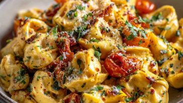 "A bowl of creamy tortellini pasta with cherry tomatoes, fresh basil, and parmesan, ready in 30 minutes."