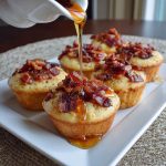 Maple bacon pancake muffins topped with crispy bacon pieces and drizzled with syrup