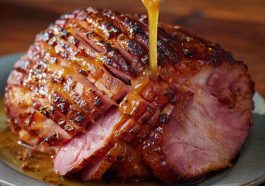 Honey mustard glazed ham sliced and served on a holiday platter