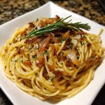 Caramelized onion and garlic spaghetti tossed with golden onions, roasted garlic, olive oil, and fresh herbs.