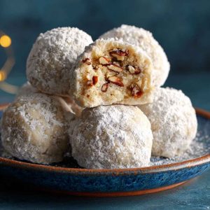 Buttery pecan snowball cookies coated in powdered sugar, with a rich, nutty flavor and melt-in-your-mouth texture.