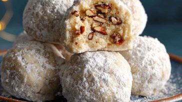 Buttery pecan snowball cookies coated in powdered sugar, with a rich, nutty flavor and melt-in-your-mouth texture.