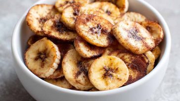 "A basket of crispy air fryer cinnamon banana chips served as a healthy snack."