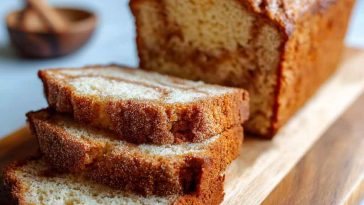 Sourdough discard cinnamon quick bread sliced with visible cinnamon swirl