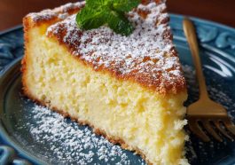 Italian lemon custard cake with a golden crust, creamy custard center, and dusting of powdered sugar served on a rustic plate.