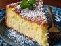 Italian lemon custard cake with a golden crust, creamy custard center, and dusting of powdered sugar served on a rustic plate.