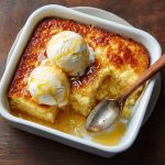 Golden baked magic lemon cobbler with a gooey lemon filling and a crisp buttery topping, served warm in a dish.