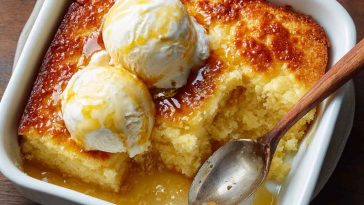 Golden baked magic lemon cobbler with a gooey lemon filling and a crisp buttery topping, served warm in a dish.