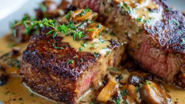 "A perfectly seared French steak topped with rich cognac cream sauce, garnished with fresh herbs."