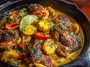 Brazilian coconut chicken served in a skillet with creamy coconut sauce and fresh herbs