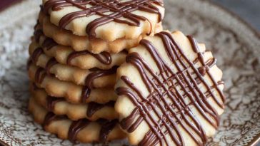 Piped chocolate butter cookies with delicate swirls, rich cocoa flavor, and a crisp buttery texture baked golden brown.