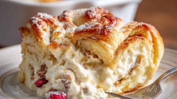 Cheesecake crescent rolls casserole baked golden brown, with creamy cheesecake filling layered between buttery crescent dough.