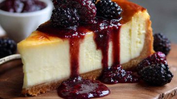 London Fog Basque cheesecake infused with Earl Grey tea, topped with blackberry sauce and dusted with powdered sugar.