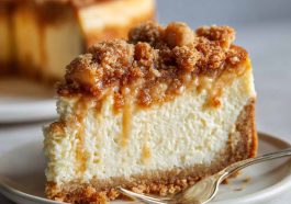 Apple crumble cheesecake topped with buttery streusel, baked golden brown, with creamy cheesecake filling and spiced apples.