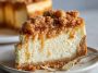 Apple crumble cheesecake topped with buttery streusel, baked golden brown, with creamy cheesecake filling and spiced apples.