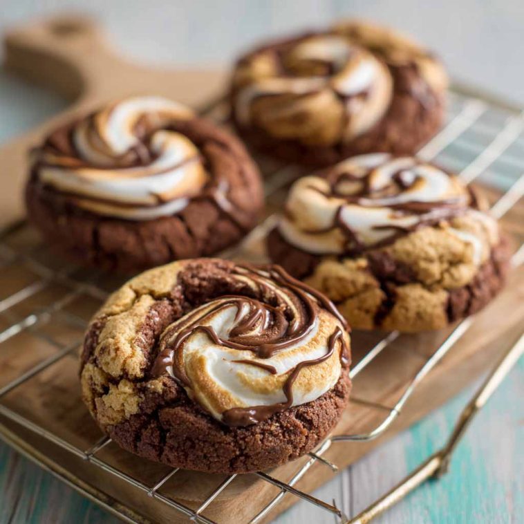 Chocolate marshmallow swirl cookies with gooey marshmallow ribbons baked into rich chocolate cookie dough, served on a rustic tray.