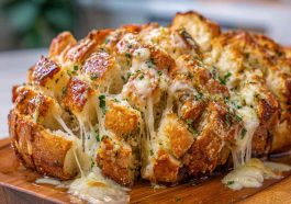 Cheesy pull-apart garlic bread baked golden brown, stuffed with melted mozzarella, garlic butter, and fresh herbs.