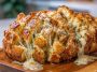 Cheesy pull-apart garlic bread baked golden brown, stuffed with melted mozzarella, garlic butter, and fresh herbs.
