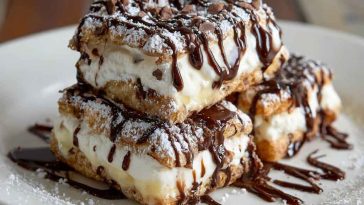 Classic cannoli squares with creamy ricotta filling, chocolate chips, and powdered sugar dusted on top.