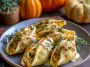 Pumpkin and Gouda stuffed pasta shells baked in creamy brown butter sage Alfredo sauce, garnished with fresh herbs.