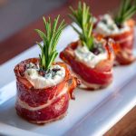Prosciutto wrapped Boursin cheese appetizer with creamy garlic herb cheese wrapped in salty prosciutto slices, served on a wooden board.