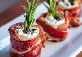 Prosciutto wrapped Boursin cheese appetizer with creamy garlic herb cheese wrapped in salty prosciutto slices, served on a wooden board.