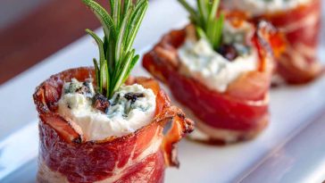Prosciutto wrapped Boursin cheese appetizer with creamy garlic herb cheese wrapped in salty prosciutto slices, served on a wooden board.