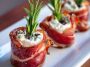 Prosciutto wrapped Boursin cheese appetizer with creamy garlic herb cheese wrapped in salty prosciutto slices, served on a wooden board.