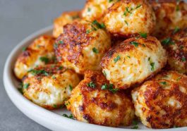 Two ingredient cottage cheese tots baked golden brown, crispy on the outside and soft inside, served as a healthy snack.