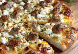 Hot sausage feta honey pizza topped with spicy sausage, creamy feta, and a drizzle of golden honey on a crispy crust.