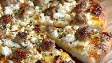 Hot sausage feta honey pizza topped with spicy sausage, creamy feta, and a drizzle of golden honey on a crispy crust.