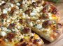 Hot sausage feta honey pizza topped with spicy sausage, creamy feta, and a drizzle of golden honey on a crispy crust.