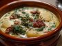 Zuppa Toscano soup with Italian sausage, kale, potatoes, and creamy broth served in a rustic bowl.