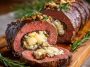 Quick Christmas stuffed beef tenderloin filled with savory herbs, garlic, and cheese, sliced and served on a festive holiday platter.