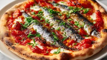 Sardine margherita pizza topped with mozzarella, basil, and fresh sardines