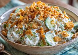 Fresh cucumber ranch crack salad with crisp cucumbers, creamy ranch dressing, shredded cheese, and crunchy bacon bits served in a bowl.