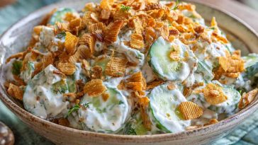 Fresh cucumber ranch crack salad with crisp cucumbers, creamy ranch dressing, shredded cheese, and crunchy bacon bits served in a bowl.