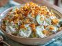 Fresh cucumber ranch crack salad with crisp cucumbers, creamy ranch dressing, shredded cheese, and crunchy bacon bits served in a bowl.