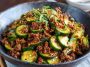 Spicy Korean ground beef served with fresh cucumber salad, garnished with sesame seeds and scallions.