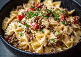 Bowtie pasta tossed in creamy Cajun Alfredo sauce with cream cheese, spiced ground beef, and fresh herbs.