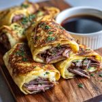 “Golden baked French dip tortilla roll ups filled with roast beef, melted cheese, and served with au jus dipping sauce.”