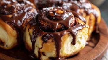 Irresistible chocolate cinnamon rolls drizzled with melted chocolate glaze, swirled with rich cocoa and cinnamon filling.