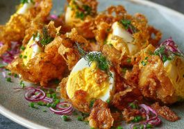 "A fresh crispy egg salad served in a bowl with crunchy lettuce, creamy dressing, and golden toasted bread on the side."