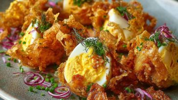 "A fresh crispy egg salad served in a bowl with crunchy lettuce, creamy dressing, and golden toasted bread on the side."