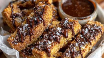 Crunchy homemade brown butter chocolate chip cookie fries served in a basket with dipping chocolate sauce, golden and crispy on the edges.