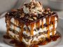"A layered no-bake turtle lasagna dessert with creamy chocolate pudding, caramel drizzle, whipped topping, and crunchy pecans."