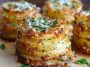 “Golden, crispy garlic Parmesan potato stacks baked in muffin tins, layered thinly and topped with fresh herbs.”