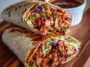 Sweet chili chicken wraps filled with tender chicken, crisp veggies, and a drizzle of tangy-sweet chili sauce.