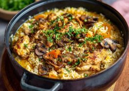 One-pot coconut chicken brothy rice served warm in a bowl, cozy dinner with creamy broth and tender chicken.